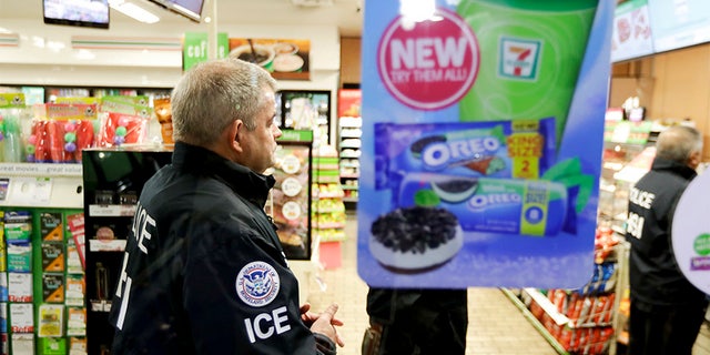 U.S. Immigration and Customs Enforcement agents serve an employment audit notice at a 7-Eleven convenience store Wednesday, Jan. 10, 2018, in Los Angeles, Calif.