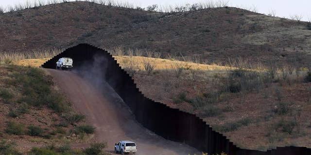U.S. Border Patrol agents patrolling the border fence near Naco, Ariz.