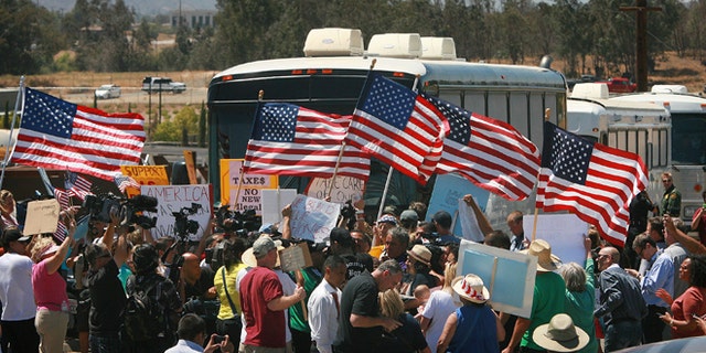 July 1, 2014: Protesters turn back three buses carrying 140 immigrants as they attempt to enter the Murrieta U.S. Border Patrol station for processing.