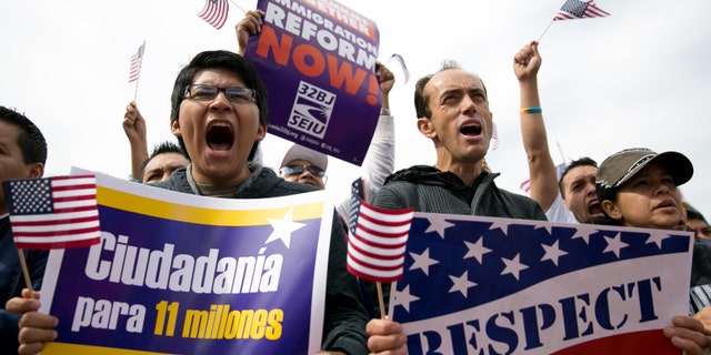 WASHINGTON, DC - OCTOBER 8: (L to R) Hernan Morales, a student at American University, and Juan Martinez, cheer during a rally in support of immigration reform, in Washington, on October 8, 2013 in Washington, DC. Last week, House Democrats introduced their own immigration reform bill. (Photo by Drew Angerer/Getty Images)