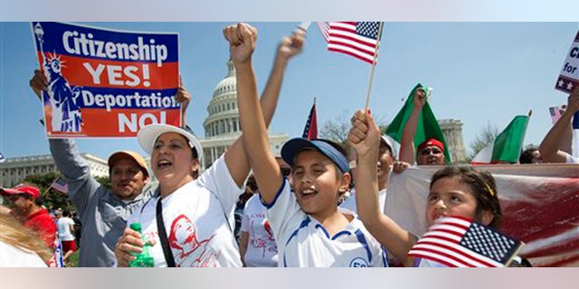Adita Chicas, left, and her son Jessy Chicas, 10, of Woodbridge, Va., cheer as they arrive at the "Rally for Citizenship" on Capitol, Hill in Washington, Wednesday, April 10, 2013, where tens of thousands of immigrants and their supporters are expected to rally for immigration reform. Bipartisan groups in the House and Senate are said to be completing immigration bills that include a pathway to citizenship for the nation's 11 million immigrants with illegal status. (AP Photo/Jacquelyn Martin)