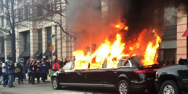 Protesters set a parked limousine on fire in downtown Washington, Friday, Jan. 20, 2017, during the inauguration of President Donald Trump.