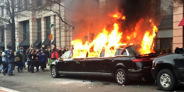 Protesters set a parked limousine on fire in downtown Washington, Friday, Jan. 20, 2017, during the inauguration of President Trump.