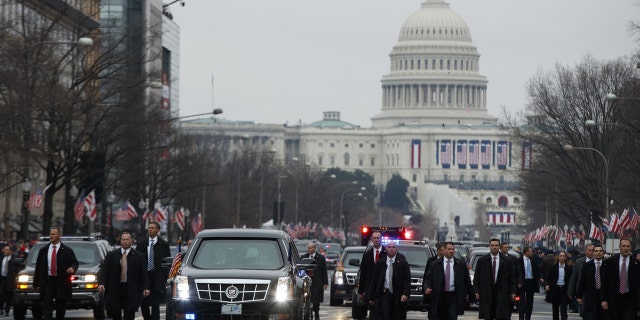 Secret Service agents escort President Donald Trump's vehicle along the inauguration day parade route after he was sworn in as the 45th President of the United States, Friday, Jan. 20, 2017, in Washington.