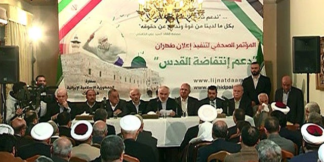 Iranian Ambassador to Lebanon Mohammad Fatahali, (center), makes announcement at press conference in Beirut.