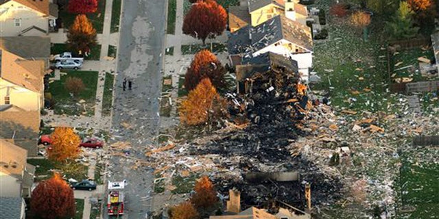 In this Nov. 11, 2012 file aerial photo, two homes that were leveled and the numerous neighboring homes that were damaged from a massive explosion that sparked a huge fire and killed two people are shown in Indianapolis.