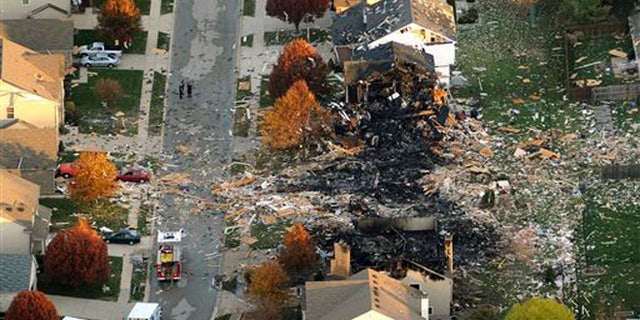 In this Nov. 11, 2012 file aerial photo, two homes that were leveled and the numerous neighboring homes that were damaged from a massive explosion that sparked a huge fire and killed two people are shown in Indianapolis.