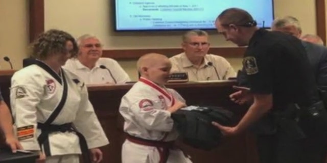 Richie Scott presents protective tactical vests to the Franklin Police Department.
