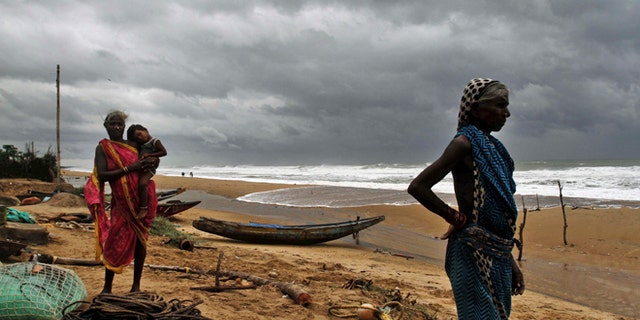 Oct. 11, 2014: Fisherwomen watch the sea waves before evacuating the place near Podampeta village, on the outskirts of Gopalpur beach in Ganjam district, 140 kilometers (87 miles) south of Bhubaneswar, India.