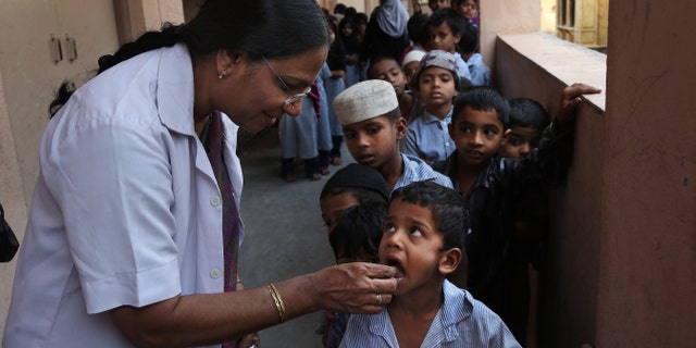 Feb. 10, 2016: Indian schoolchildren line up to take a deworming tablet in Hyderabad, India.
