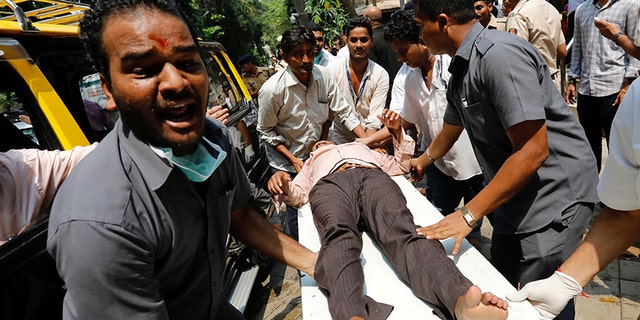 Sept. 29, 2017: A stampede victim is carried on a stretcher at a hospital in Mumbai, India.
