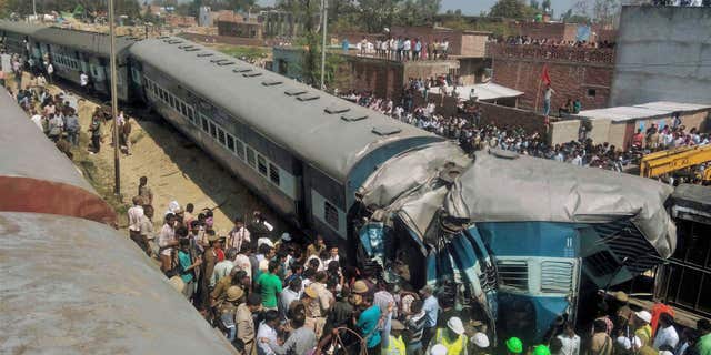 MArch 20, 2015: Indian rescue workers gather at the site of a train accident near Bachhrawan village in Uttar Pradesh state, India.