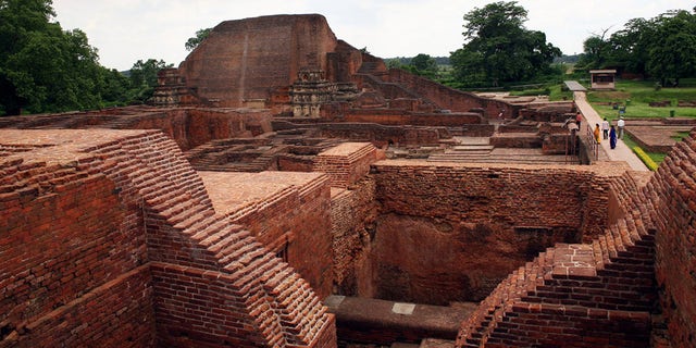In this July 5, 2006 file photo, tourists walk at the ruins of the Nalanda University at Nalanda, India. UNESCO has put four new sites on its World Heritage List, including the archaeological site of Nalanda Mahavihara, or Nalanda University, on Friday, July 15, 2016.