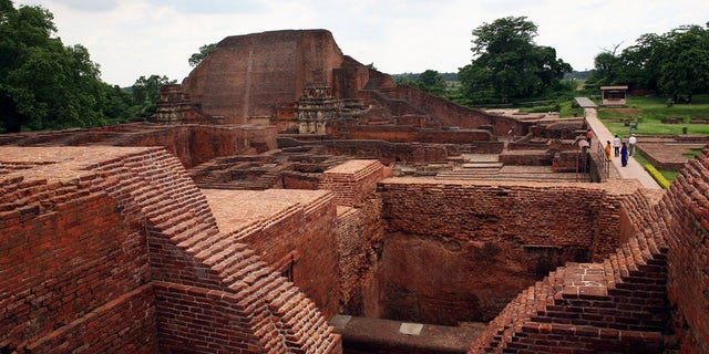 In this July 5, 2006 file photo, tourists walk at the ruins of the Nalanda University at Nalanda, India. UNESCO has put four new sites on its World Heritage List, including the archaeological site of Nalanda Mahavihara, or Nalanda University, on Friday, July 15, 2016.