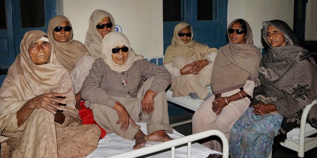 Indian elderly women who went blind following cataract surgeries performed at a free medical camp run by a charity sit together as they receive treatment at a hospital in Amritsar, India, Friday, Dec. 5, 2014. (AP Photo/Press Trust of India)