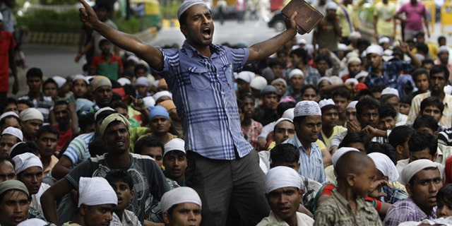 July 25, 2012: Muslims hailing from India's north eastern Assam state and living in New Delhi shout slogans during a protest against the ethnic violence in Assam in New Delhi, India.