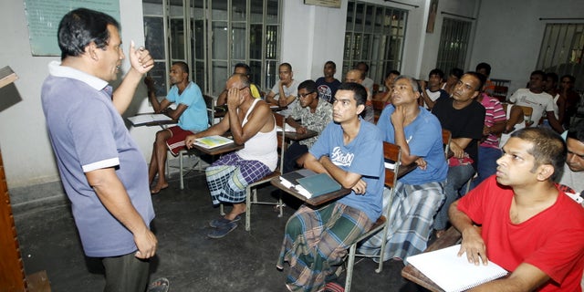 A councillor (L) talks to drug addicts in a classroom at the Bangladesh Rehabilitation and Assistance Centre for Addicts (BARACA) in Dhaka September 12, 2015. REUTERS/Ashikur Rahman