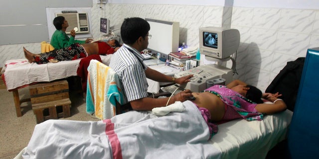 Indian gynaecologists conduct ultrasound examinations on pregnant women at a government-run hospital in the northeastern Indian city of Agartala March 17, 2015. REUTERS/Jayanta Dey