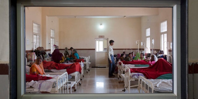 Women who have recently given birth and their relatives are pictured through a nurse';s observaton window as they rest in a post delivery ward at a district hospital in Shivpuri, in the central Indian state of Madhya Pradesh, February 25, 2012. REUTERS/Vivek Prakash