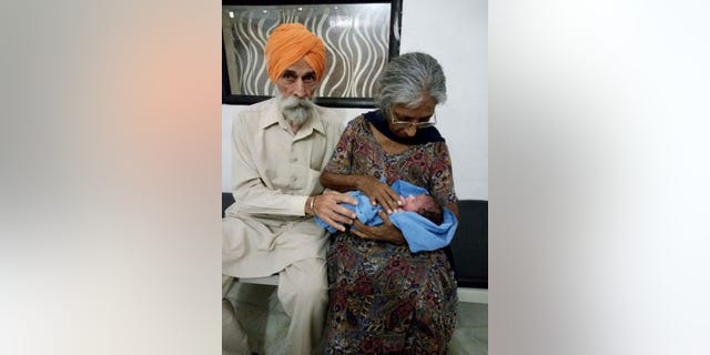 A man carries a newborn baby at a hospital in this file photo.
