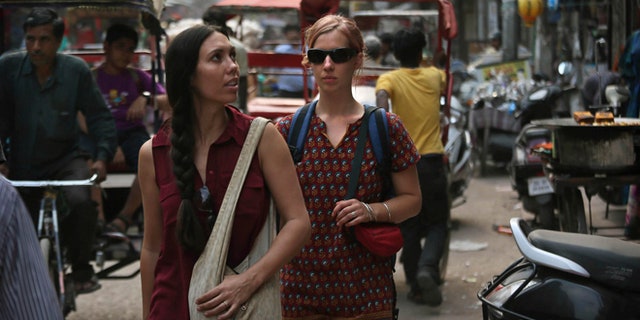 April 2, 2013: In this photo, foreign tourists walk on a street near the railway station in New Delhi, India. Violence against women, and the huge publicity generated by recent attacks here, is threatening India's $17.7 billion tourism industry. A new study shows tourism has plunged, especially among women, since a 23-year-old Indian student was raped on a New Delhi bus and later died from her injuries, a case that garnered worldwide publicity.