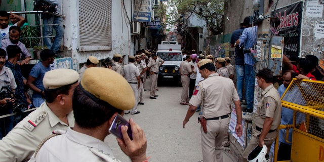 India Police next the house where 11 bodies were found in Burari village, north Delhi, India, Sunday, July 1, 2018.