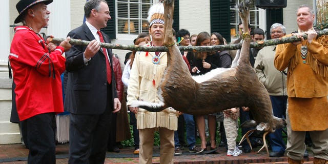 Nov. 25, 2009: Pamunkey Councilmen Jeff Brown, left, and Gary Miles, hold a deer as their Chief Kevin Brown presents it to Gov. Tim Kaine, second from left, during the annual tax tribute from the Virginia Indians to the Virginia governor. Several members of the Congressional Black Caucus are urging the Obama administration to withhold federal recognition of the Pamunkey tribe in southeast Virginia because of its history of banning intermarriage with blacks.