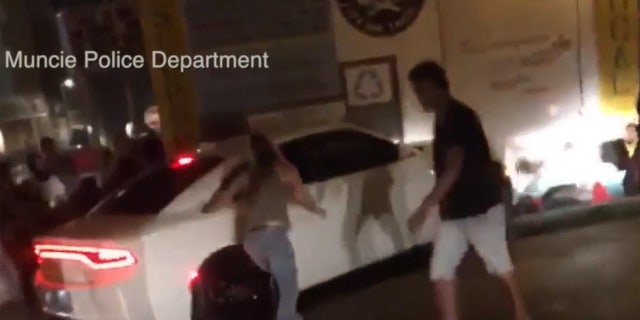 People can be seen getting knocked over by the car.