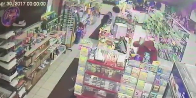A suspect is seen beating a convenience store clerk in Muncie, Ind.
