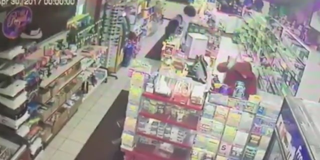 A suspect is seen beating a convenience store clerk in Muncie, Ind.
