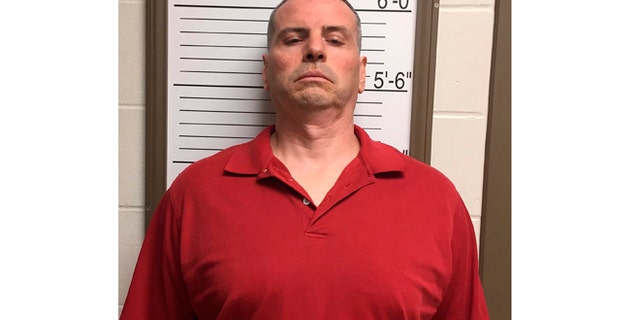 April 24, 2015: In this photo provided by the Brown County Sheriff's Dept. via the Bloomington Herald-Times Daniel Messel stands against a height board for a booking photo at the Brown County Jail in Nashville, Ind.