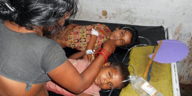 July 16, 2013: Schoolchildren receive treatment at a hospital after falling ill soon after eating a free meal at a primary school in Chhapra district, in the eastern Indian state of Bihar.