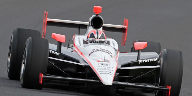 Helio Castroneves makes a qualifying run at the Indianapolis Motor Speedway