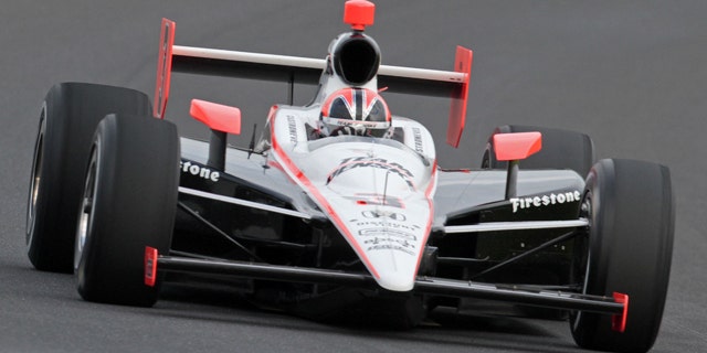 Helio Castroneves makes a qualifying run at the Indianapolis Motor Speedway