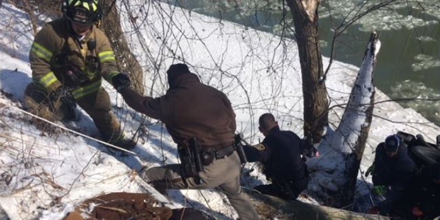 Rescues had to scale a frozen river bank down to where the man ended up upside-down in an icy Indiana River.