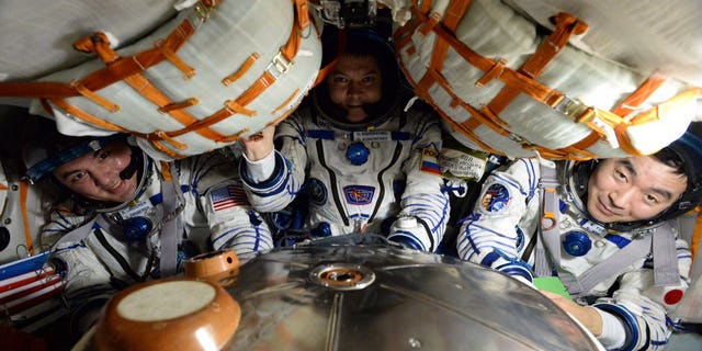 Expedition 45 crew members Kjell Lindgren of NASA, Oleg Kononenko of the Russian Federal Space Agency and Kimiya Yui of the Japan Aerospace Exploration Agency settle into the Soyuz TMA-17M spacecraft that carried them safely back to Earth on Dec. 11, 2015 after their 141-day mission aboard the International Space Station. (NASA)