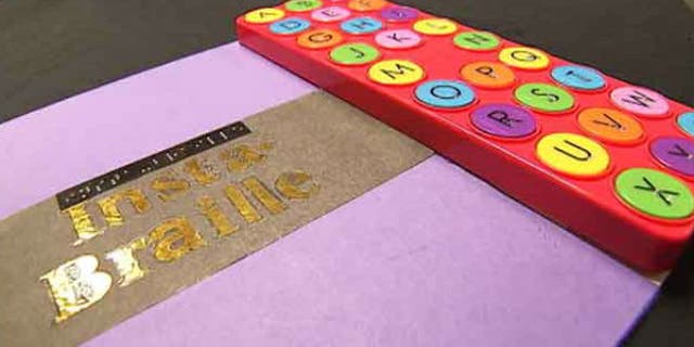 To use the Insta-Braille, a reader feels a Braille character, pushes the button, then hears the word of the alphabet it represents. (image: My Fox Atlanta)