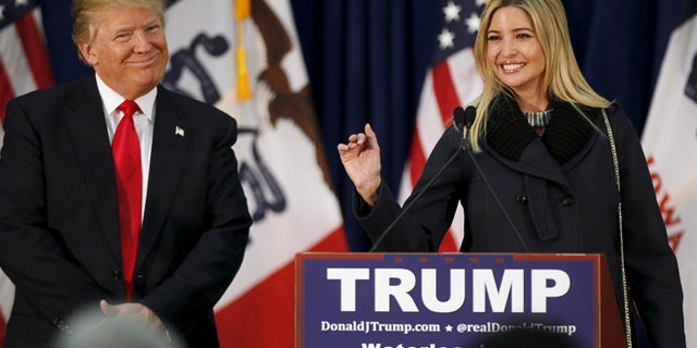 U.S. Republican presidential candidate Donald Trump listens as his daughter Ivanka speaks at a campaign rally on caucus day in Waterloo, Iowa February 1, 2016. REUTERS/Rick Wilking - RTX24YNA