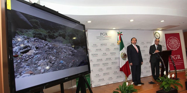 FILE - In this Dec. 7, 2014, file photo, Mexico's Attorney General, Jesus Murillo Karam, right, flanked by Tomas Zeron director of Mexico's Criminal Investigation Agency, speaks during a news conference in Mexico City. The Attorney Generalââ¬â¢s Office has announced on Wednesday, Sept. 14, 2016, the resignation of Tomas Zeron, whose dismissal had been demanded by the families of 43 college students who disappeared two years ago. (AP Photo/Marco Ugarte, File)