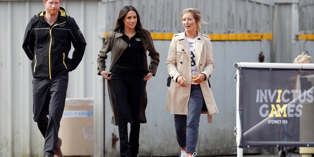 Prince Harry and Meghan Markle walk the track during the game trials.