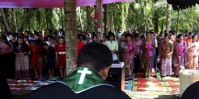 Oct. 18: Residents pray as they attend Sunday mass at a temporary shelter near a burned church at Suka Makmur Village in Aceh Singkil, Indonesia Aceh province.
