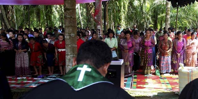 Oct. 18: Residents pray as they attend Sunday mass at a temporary shelter near a burned church at Suka Makmur Village in Aceh Singkil, Indonesia Aceh province.