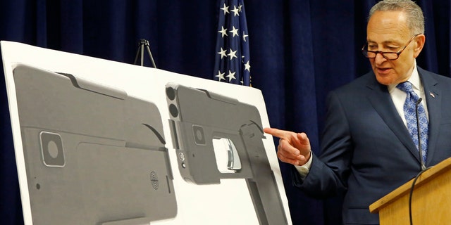 April 4, 2016: U.S. Sen Charles Schumer, (D-New York), points to photographs of what appears to be a cell phone, but is actually a handgun, during a press conference in his office