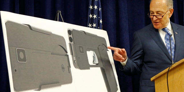 April 4, 2016: U.S. Sen Charles Schumer, (D-New York), points to photographs of what appears to be a cell phone, but is actually a handgun, during a press conference in his office
