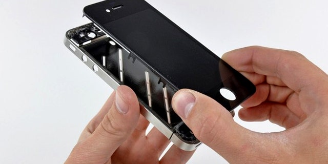 The front panel is removed from the iPhone 4 during a teardown in San Luis Obispo, California. Apple Inc's hot-selling next-generation iPhone sports chips from Samsung Electronics, Micron Technology and STMicroelectronics, according to an early teardown, or disassembly analysis by technology firm iFixit.