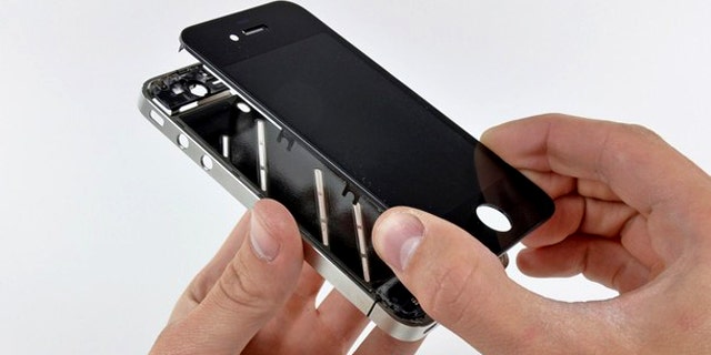 The front panel is removed from the iPhone 4 during a teardown in San Luis Obispo, California. Apple Inc's hot-selling next-generation iPhone sports chips from Samsung Electronics, Micron Technology and STMicroelectronics, according to an early teardown, or disassembly analysis by technology firm iFixit.