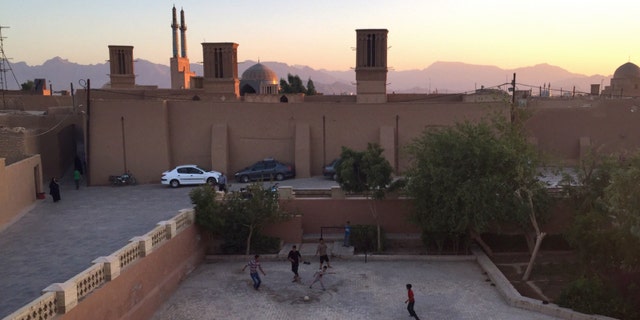 Iran Children playing soccer at sunset in Yazd, Iran