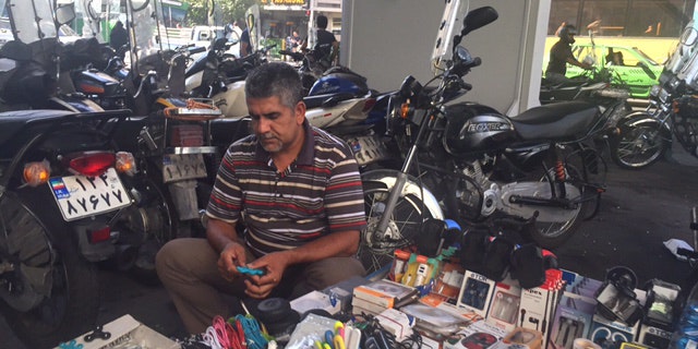 Man selling goods on the streets of Tehran, Iran