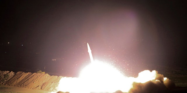 In this picture released by the Iranian state-run IRIB News Agency on Monday, June 19, 2017, a missile is fired from city of Kermanshah in western Iran targeting the Islamic State group in Syria. Iran's powerful Revolutionary Guard, a paramilitary force in charge of the country's missile program, said it launched six Zolfaghar ballistic missiles from the western provinces of Kermanshah and Kurdistan. (IRIB News Agency, Morteza Fakhrinejad via AP)