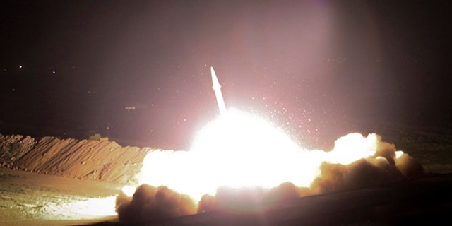 In this picture released by the Iranian state-run IRIB News Agency on Monday, June 19, 2017, a missile is fired from city of Kermanshah in western Iran targeting the Islamic State group in Syria. Iran's powerful Revolutionary Guard, a paramilitary force in charge of the country's missile program, said it launched six Zolfaghar ballistic missiles from the western provinces of Kermanshah and Kurdistan. (IRIB News Agency, Morteza Fakhrinejad via AP)